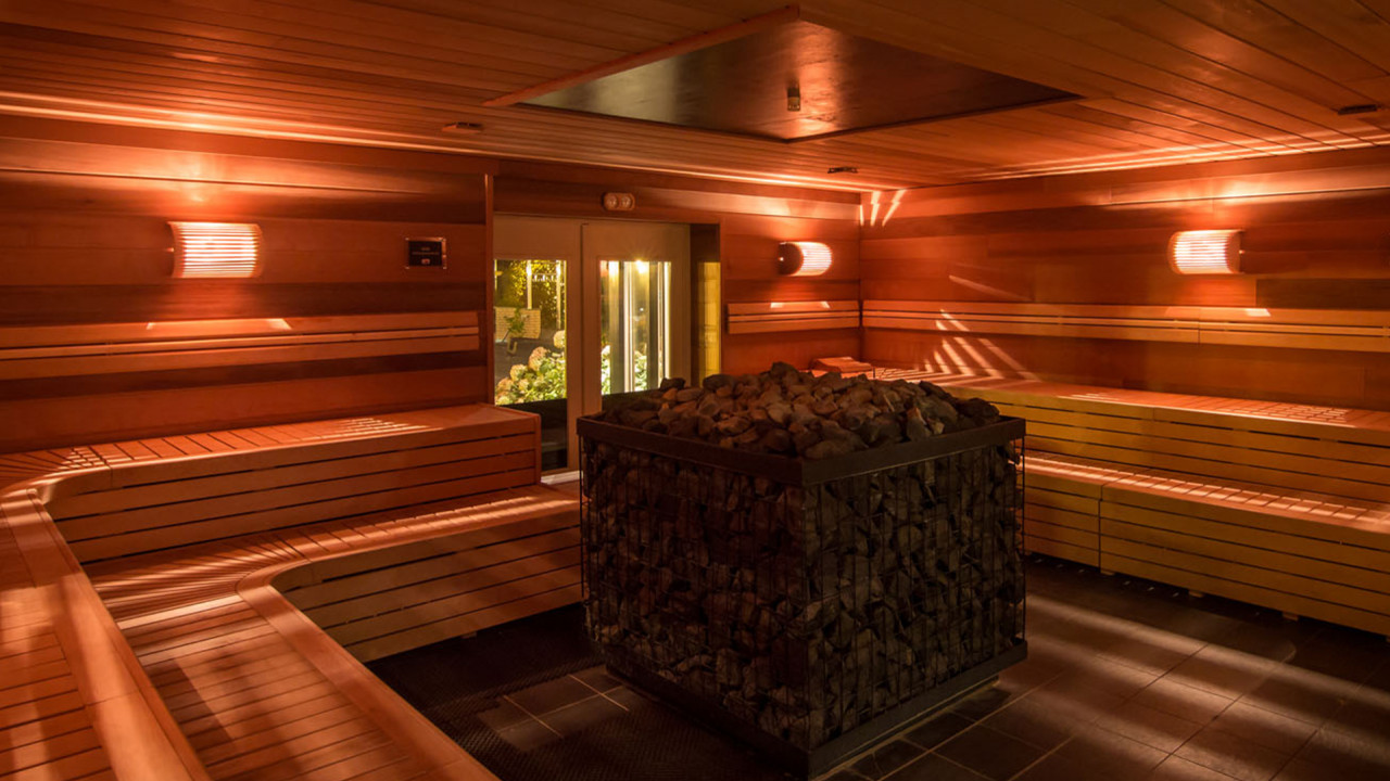 Donkere sauna met stenen kachel in het midden bij Zwaluwhoeve
